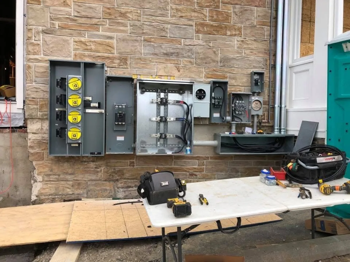 Wide view — commercial multi-panel install with bucket truck on site
