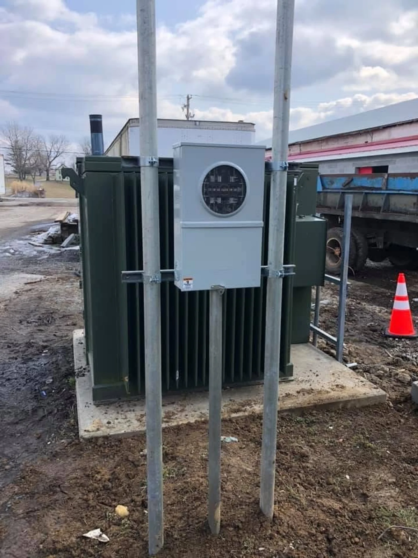 Pad-mount transformer with meter base on galvanized posts