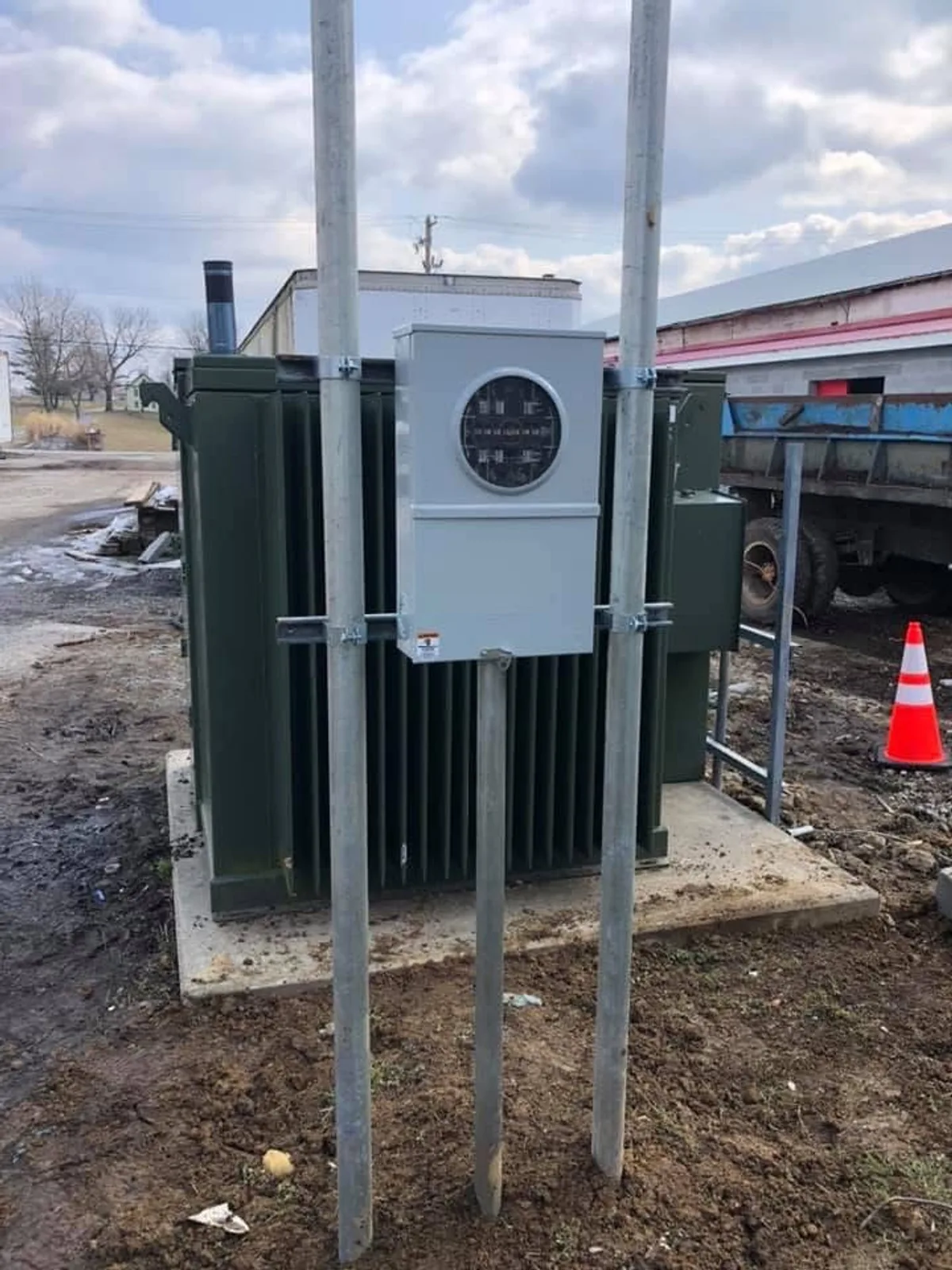 Pad-mount transformer with meter base on galvanized support posts