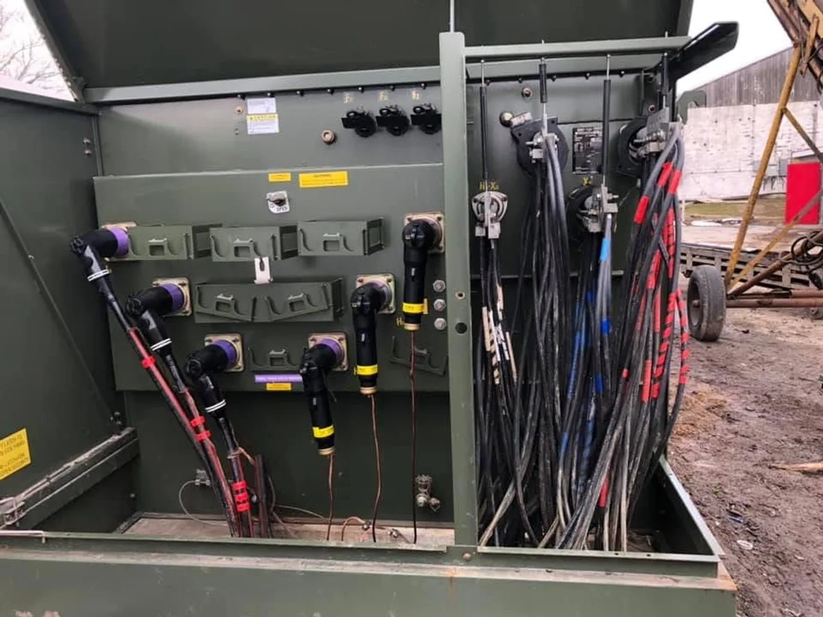 Interior of open switchgear cabinet showing organized cable terminations