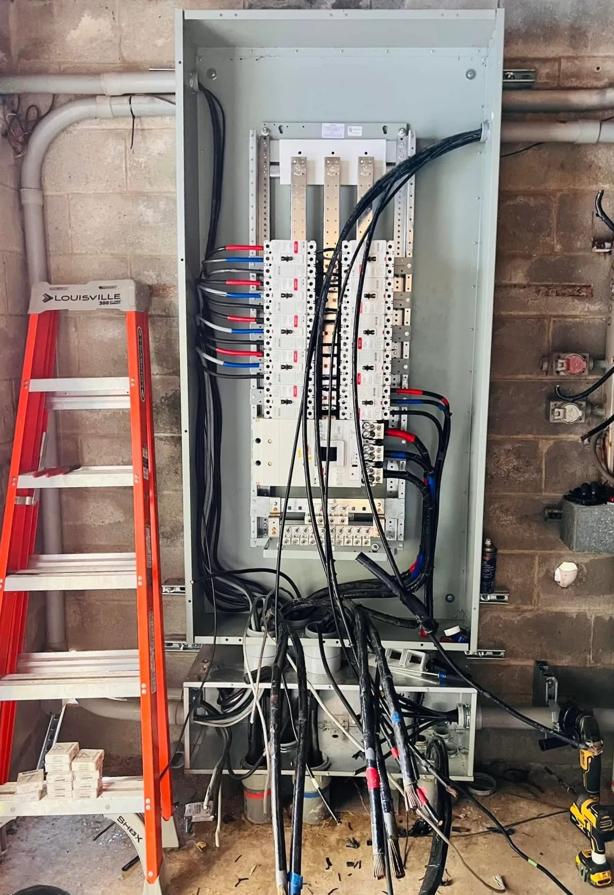 M. Luna Electric technician mid-install on commercial panel
